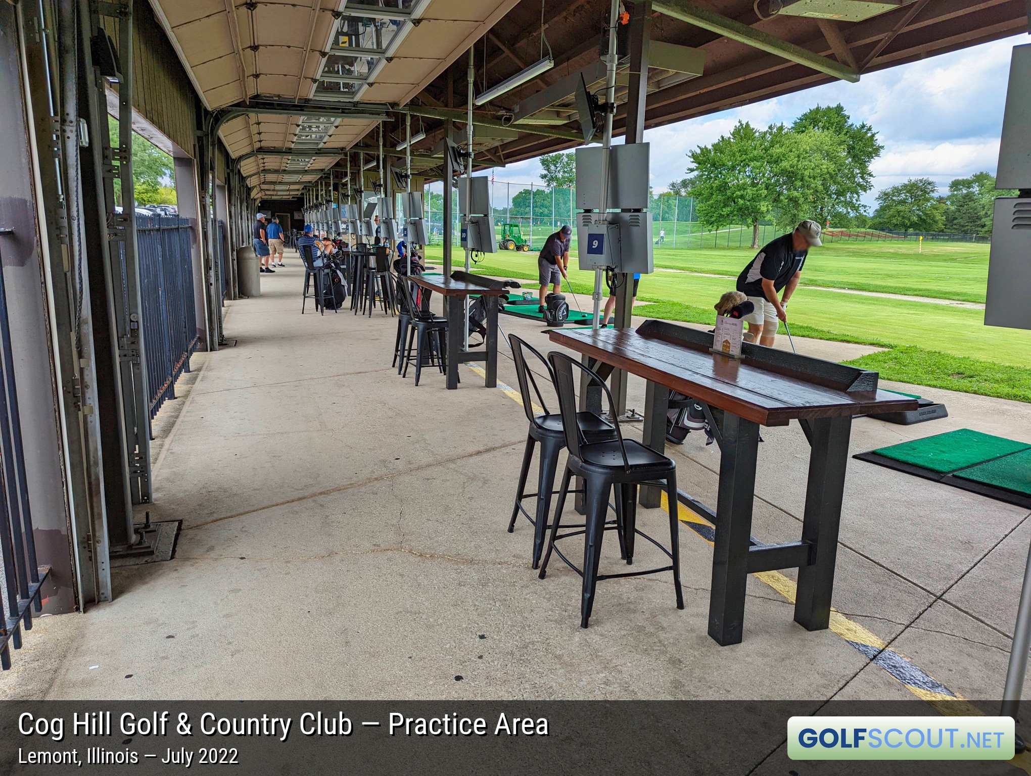 Photo of the practice area at Cog Hill Course #2 - Ravines in Lemont, Illinois. Dozens of hitting bays, at two different angles to the range. Everything is on one level -- not multiple floors.