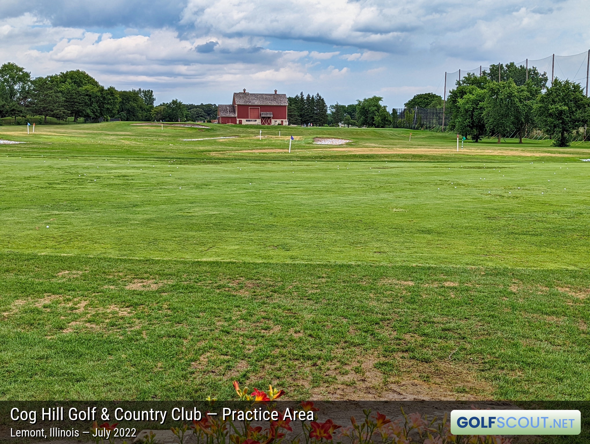 Photo of the practice area at Cog Hill Course #4 - Dubsdread in Lemont, Illinois. The old Cog Hill barn in the distance at the back of the range. Lots of flags to hit to.